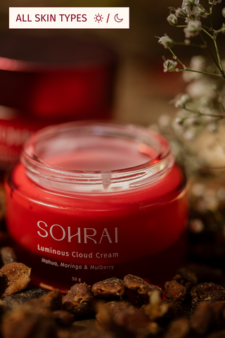Red jar of Sohrai Luminous Cloud Cream with natural ingredients on a dark background